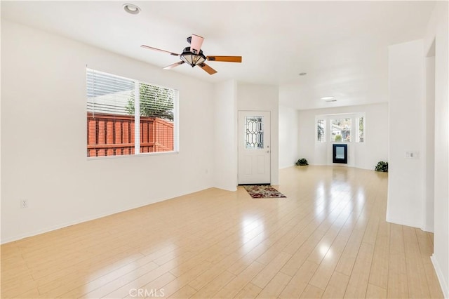 foyer with light hardwood / wood-style floors and ceiling fan