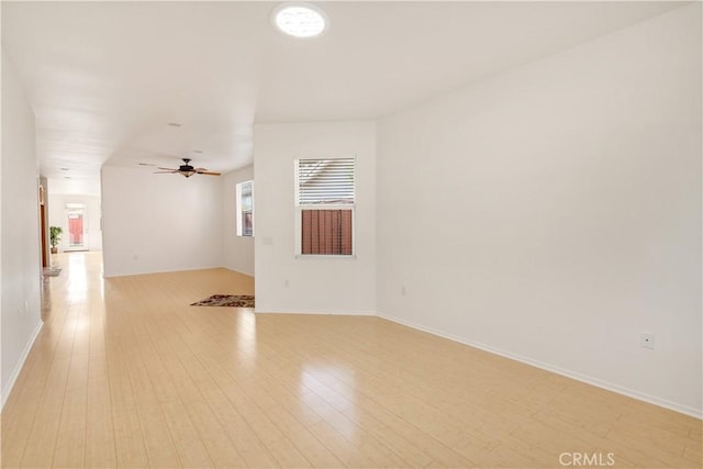 unfurnished room with ceiling fan and light wood-type flooring