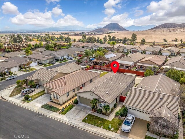 birds eye view of property featuring a mountain view