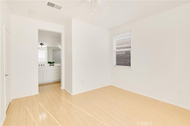 spare room with light hardwood / wood-style floors