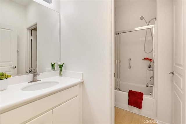 bathroom with vanity and combined bath / shower with glass door