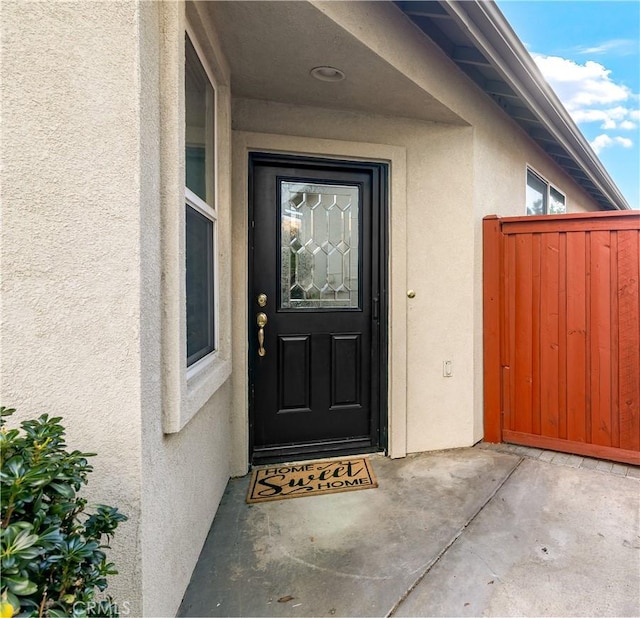 entrance to property with stucco siding