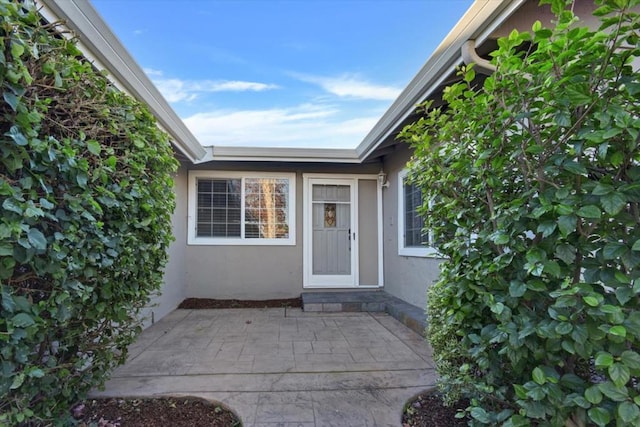 property entrance with a patio area