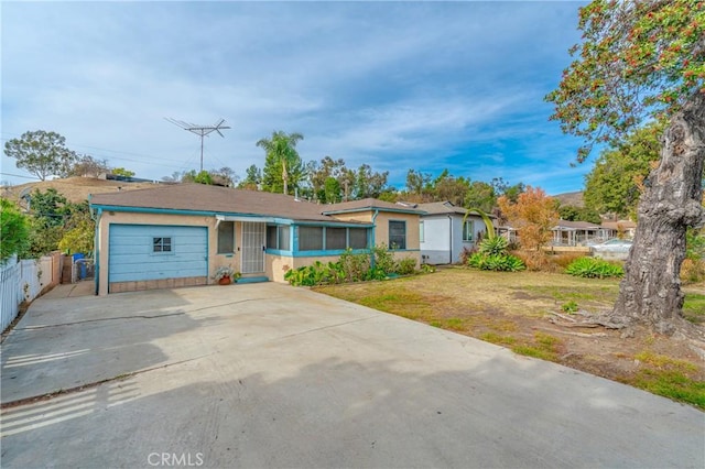 single story home with a garage and a front lawn