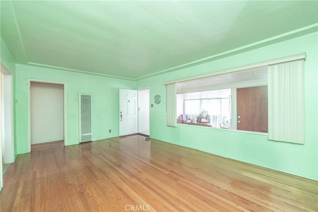 unfurnished room with wood-type flooring