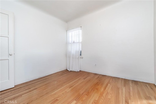 spare room with light hardwood / wood-style flooring