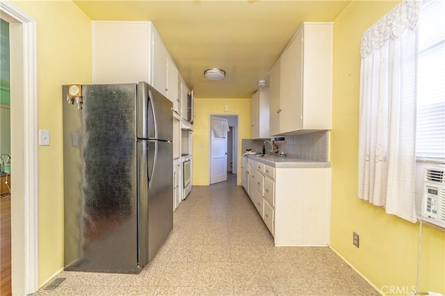 kitchen featuring white cabinetry, stainless steel appliances, sink, and decorative backsplash