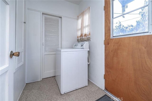 laundry area with washer / clothes dryer and light carpet