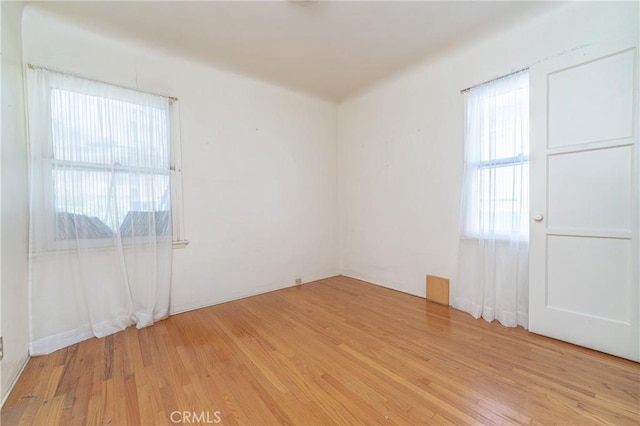 unfurnished room with light wood-type flooring