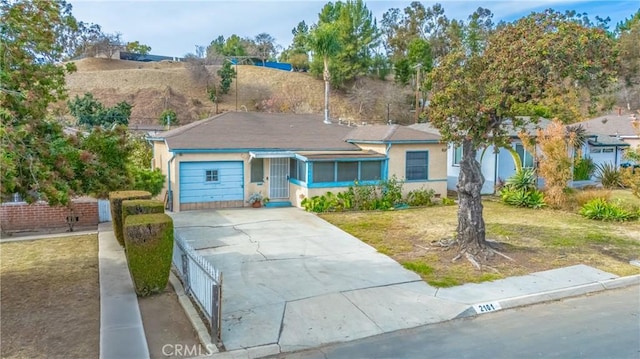 ranch-style house with a garage and a front lawn