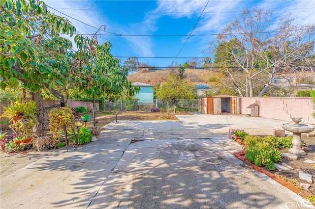 view of patio with a storage shed