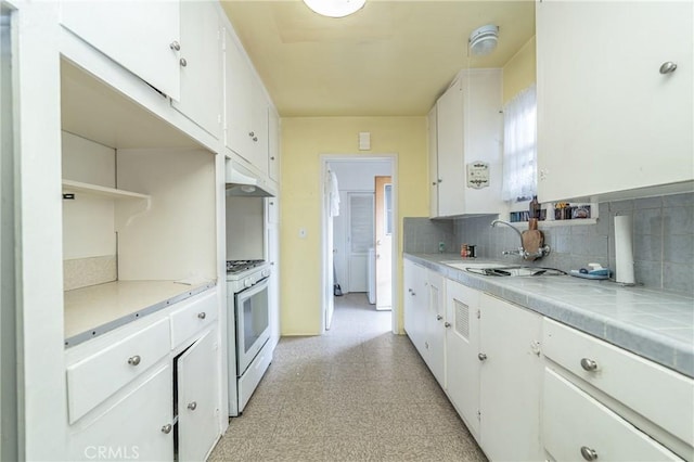 kitchen featuring ventilation hood, white cabinetry, tile countertops, and white gas range oven