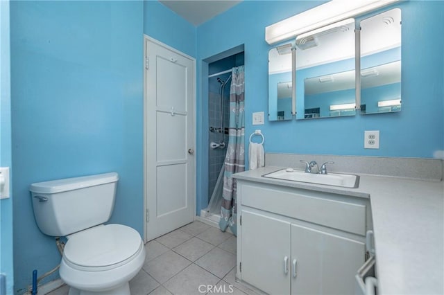 bathroom featuring tile patterned flooring, vanity, curtained shower, and toilet