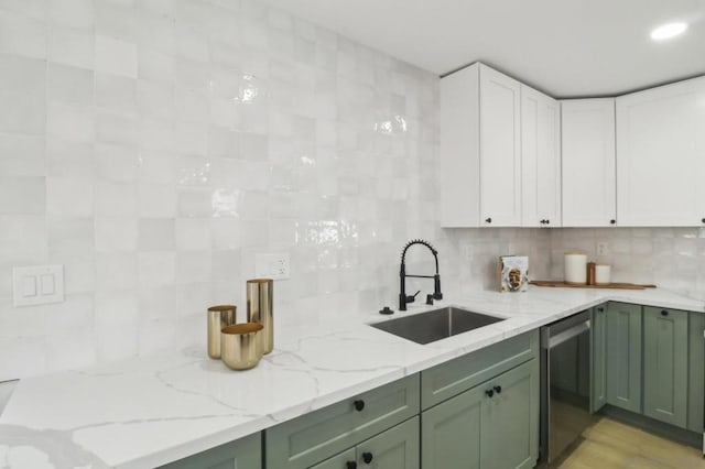 kitchen featuring green cabinetry, dishwasher, sink, and white cabinets