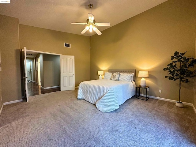 carpeted bedroom featuring ceiling fan and high vaulted ceiling