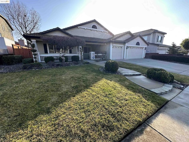 view of front of home with a garage, covered porch, and a front yard