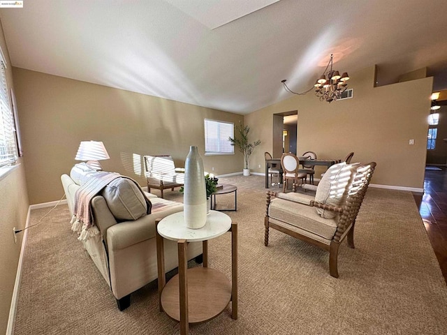 living room featuring lofted ceiling and an inviting chandelier