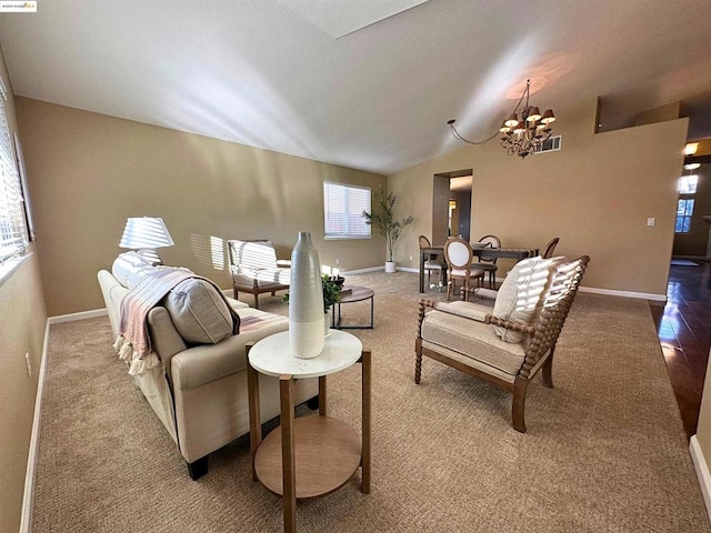 living room with vaulted ceiling and a chandelier