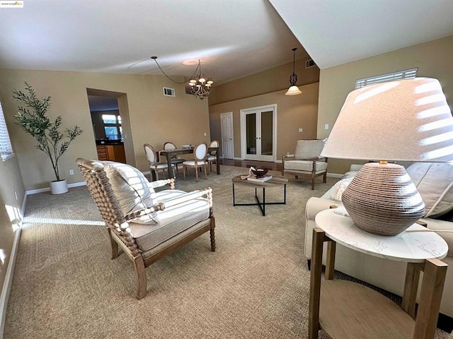 carpeted living room featuring a chandelier