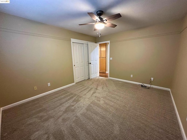 unfurnished bedroom featuring ceiling fan and carpet floors