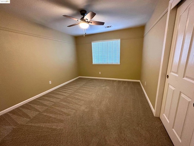 unfurnished room featuring ceiling fan and carpet floors