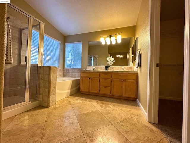 bathroom featuring tile patterned flooring, vanity, a textured ceiling, and plus walk in shower