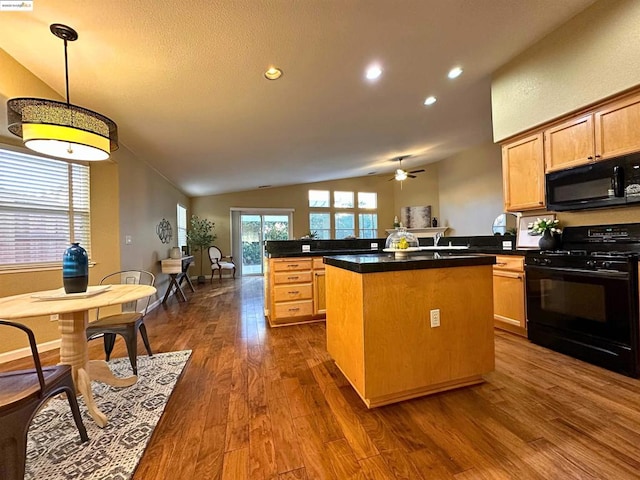 kitchen featuring a center island, vaulted ceiling, dark hardwood / wood-style flooring, kitchen peninsula, and black appliances