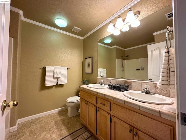 bathroom with a shower, vanity, toilet, crown molding, and a textured ceiling