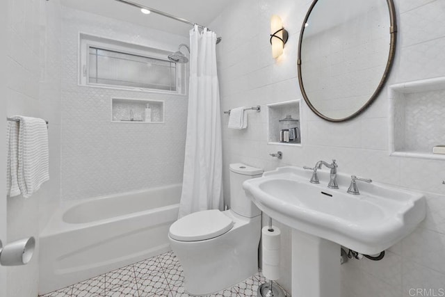 bathroom with tile walls, shower / tub combo, tile patterned floors, and toilet