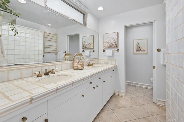 bathroom with vanity, tile patterned floors, and toilet