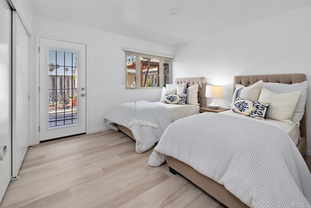 8348 Paseo Del Ocaso Ln, Jolla, CA 92037 - bedroom featuring light wood-type flooring, access to exterior, and baseboards