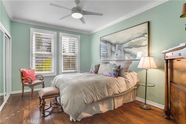 bedroom with dark wood-type flooring, ornamental molding, and ceiling fan