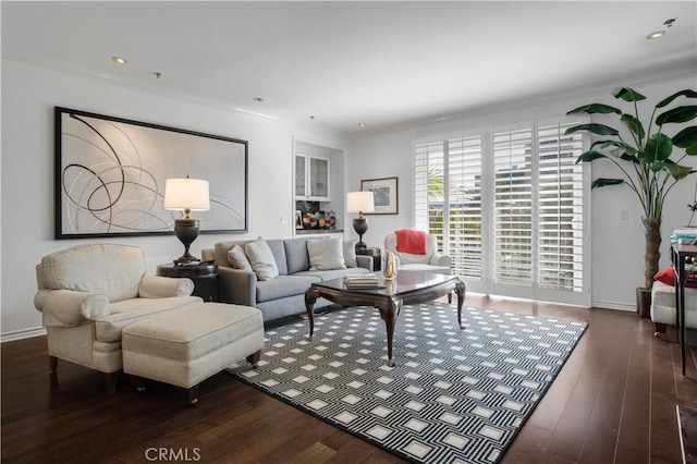 living room featuring dark wood-type flooring and crown molding