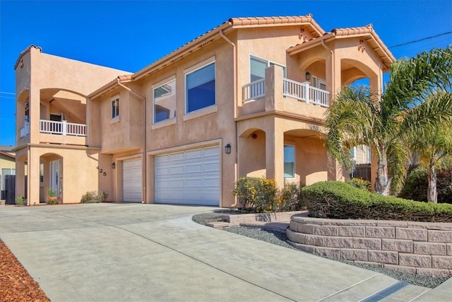 view of front of home with a garage and a balcony