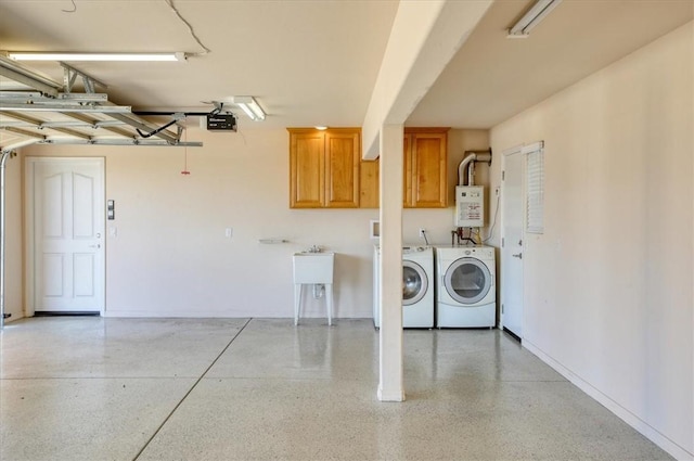 garage with water heater, separate washer and dryer, and a garage door opener