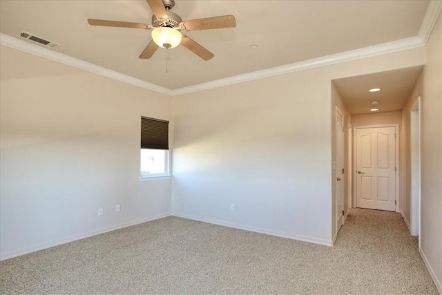 spare room with crown molding, light carpet, and ceiling fan