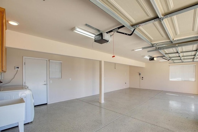 garage featuring a garage door opener and independent washer and dryer