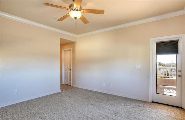 empty room featuring ceiling fan, ornamental molding, and carpet floors