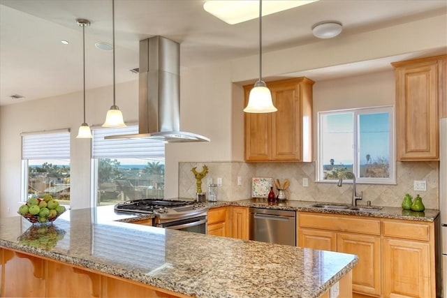 kitchen featuring pendant lighting, sink, appliances with stainless steel finishes, light stone countertops, and island exhaust hood