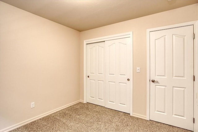 unfurnished bedroom with carpet and a closet