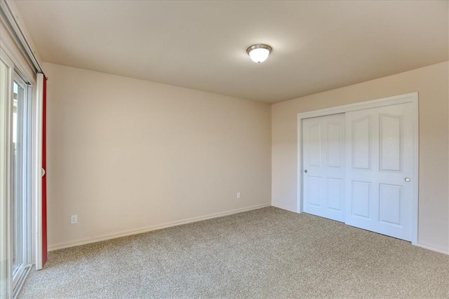 unfurnished bedroom with light carpet and a closet