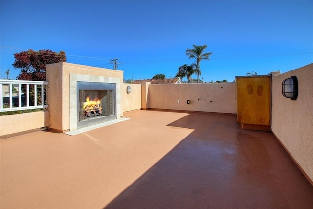 view of patio featuring exterior fireplace