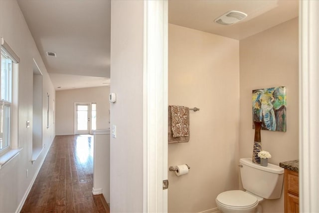 bathroom featuring vanity, toilet, and hardwood / wood-style floors