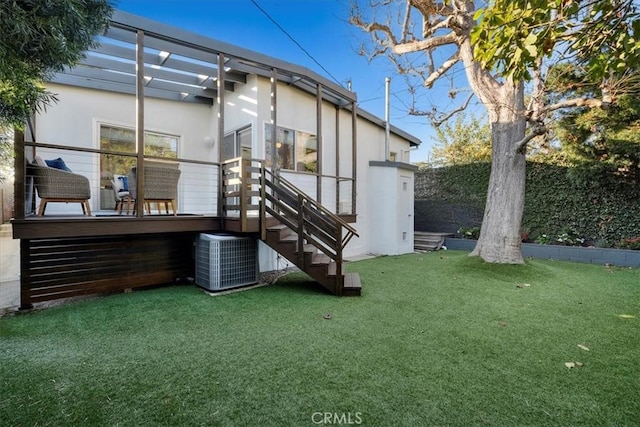 rear view of house featuring a yard and central AC unit