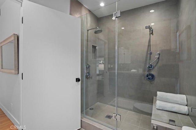 bathroom featuring a shower with shower door