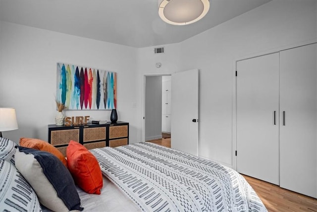 bedroom with light wood-type flooring and a closet