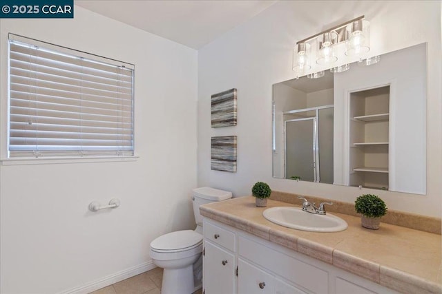 bathroom with vanity, a shower with shower door, tile patterned floors, and toilet