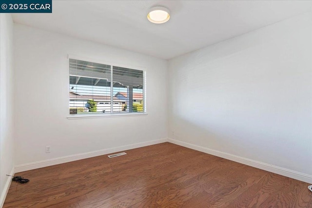 empty room with dark wood-type flooring