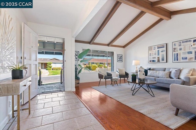 living room featuring beamed ceiling, high vaulted ceiling, and light hardwood / wood-style flooring