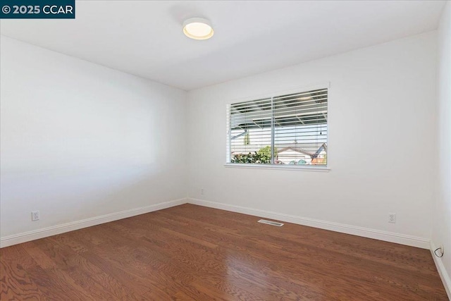 unfurnished room featuring dark hardwood / wood-style floors